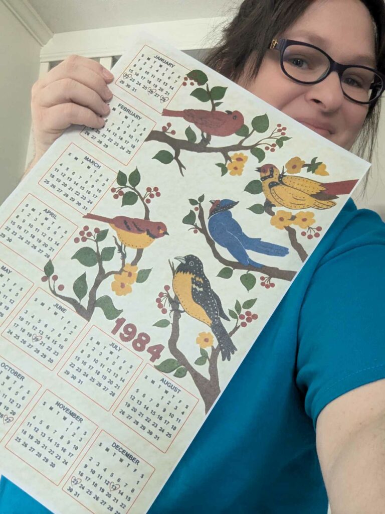 The Best Christmas Pageant Ever Prop Calendar, displaying the year 1984, with vintage birds.